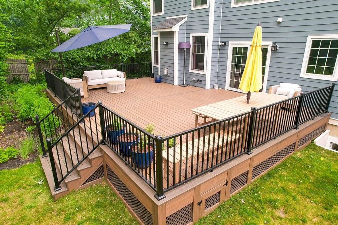Composite deck with railings and patio furniture after a low-pressure cleaning